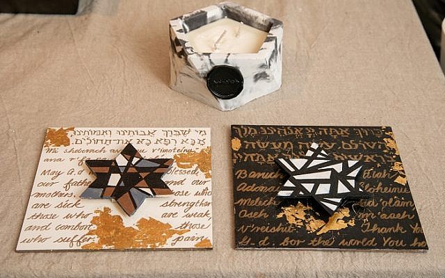 Karin’s wood blessings are in Hebrew and English. Daughter Gina’s handmade candle is atop.