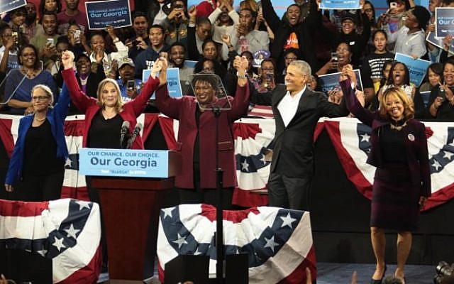 From left: Candidates Carolyn Bourdeaux, Sarah Riggs Amico, Stacey Abrams and Lucy McBath celebrate with former U.S. President Barack Obama at a campaign rally at Morehouse College’s Forbes Arena.