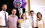 Epstein Head of Schoolwide Programs and Digital Learning and Technology Aaron Griffin, Elementary Principal David Welsher, Head of School David Abusch-Magder and Preschool Principal Stephanie Wachtel (right) present the teacher innovation award to Music Specialist Gale Berman (center).