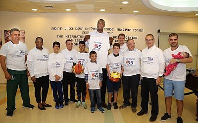 As part of his visit, Dikembe Mutombo gave away T-shirts to patients and fans.