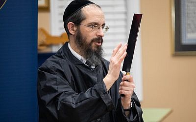 Photos by Eddie Samuels // Rabbi Amitai ben David expertly demonstrates how he checks the edge of his blade using the flesh of his finger without cutting himself.