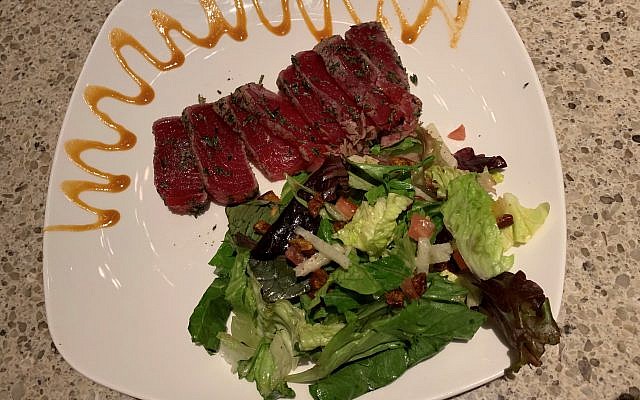 Shareable seared tuna steals the show with greens, spicy pecans and mustard coulis.