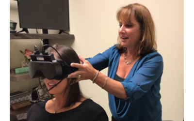 Dr. Peggy Marbach tests a patient using infrared video goggles.