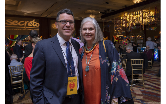Photos courtesy of Heidi Morton // Gala Chair Martha Jo Katz admires the color-laden room and throng of patrons. Pictured here with Kenny Blank, AJFF executive director.
