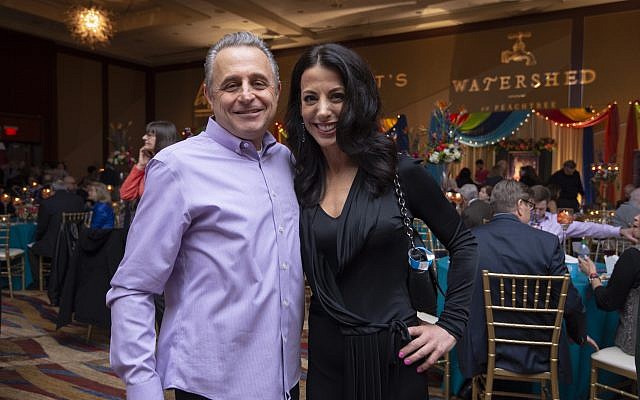 Fuego Mundo owner Udi Hershkovitz poses with Hannah Whitlock in black Balenciaga in front of the Watershed table.
