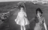 Young Behar, in her holiday best, with her mother on an oceanfront boulevard in Havana.