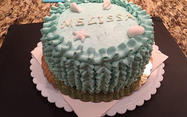 “The Melissa” cake is buttery vanilla layers studded with fresh strawberries, strawberry compote filling and frosted with vanilla Swiss meringue buttercream.