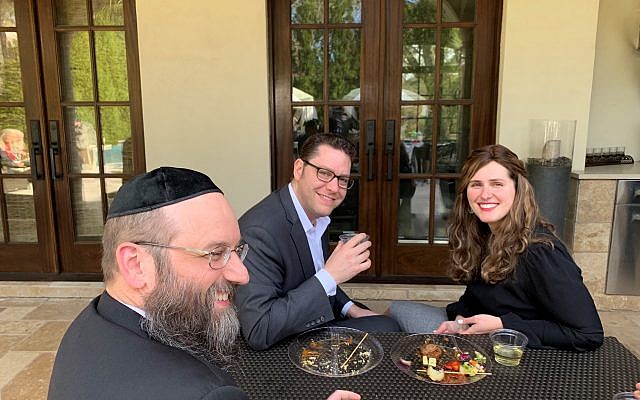 Co-Rosh Kollel Daniel Pransky, left, chats with Eric and Malka Adelman on the Goldstein patio.