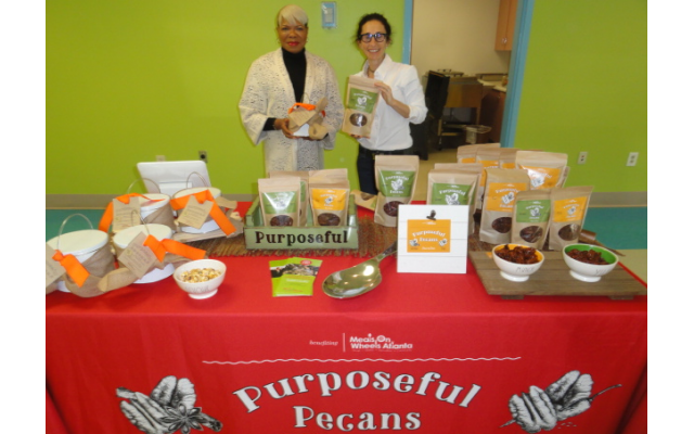 CEO Charlene Crusoe-Ingram, left, and Hillary Baker of Meals on Wheels, with some of their product.