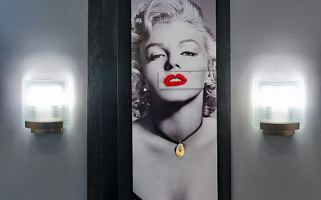 Shulman constructed this “Marilyn Monroe” mixed media for his stair landing between the sconces.