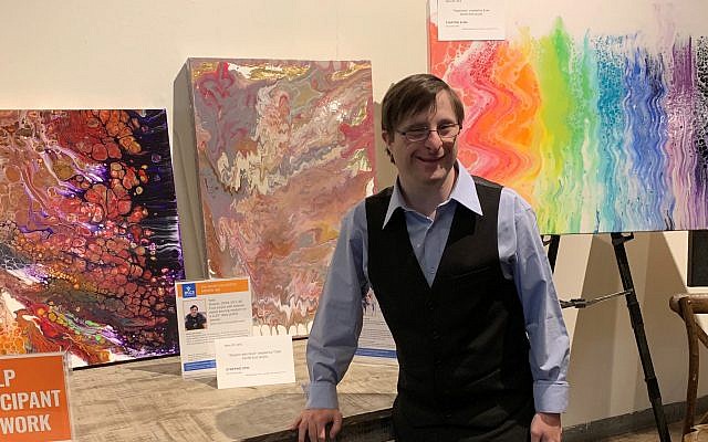 Independent Living Program participants created artwork for auction as part of The Artist Collective. Shown here is Todd Besmertnik with his “Shalom,” a fluid acrylic polymer on deep profile canvas.