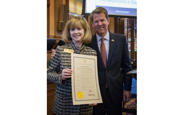 Photo by Duane Stork // Gov. Brian Kemp and Sally Levine display a Days of Remembrance proclamation.