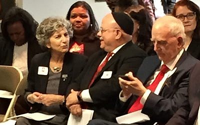 Shelley Rose, deputy director of the Anti-Defamation League regional office in Atlanta, chats with Rabbi Steve Lebow of Temple Kol Emeth before the press conference, while former Gov. Roy Barnes checks his phone.
