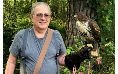 Greg Ames uses a thick glove on which to perch his red-tailed hawk, whom he has trained to kill prey.