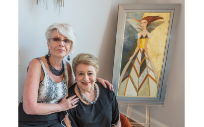 On left, designer Julia Larrabee poses alongside Sherry Habif, who enjoys her entrance foyer with Alina Eydel’s intricately beaded original  “Only the Art of the Girl in a Dress”