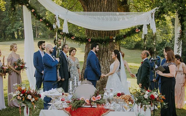 Photos by Teale Photography // Photo of the chuppah with the Persian table, Sofreh Aghd. Kamy Deljou designed the lace chuppah. The Persian table, akin to a Passover seder, was meticulously prepared.