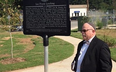 Rabbi Steve Lebow alongside the sign commemorating the Leo Frank Lynching.