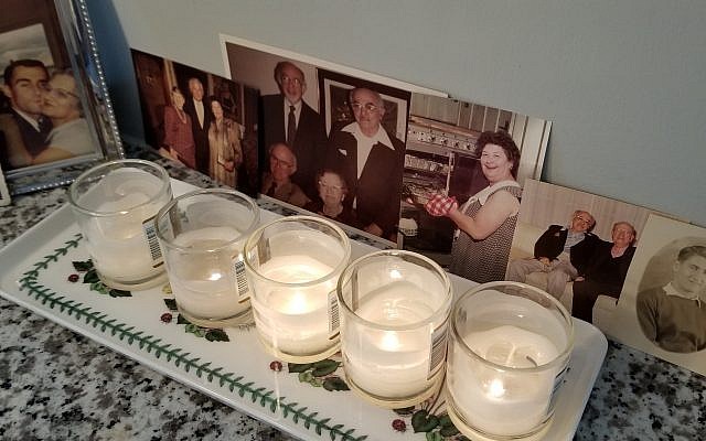 Flora Rosefsky remembers departed loved ones at Yom Kippur with photos in addition to yahrzeit candles.