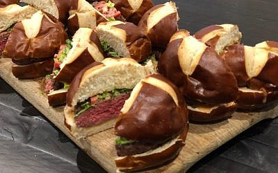EB Catering is known for its bar food like these burgers in pretzel buns with arugula, onion jam and garlic.