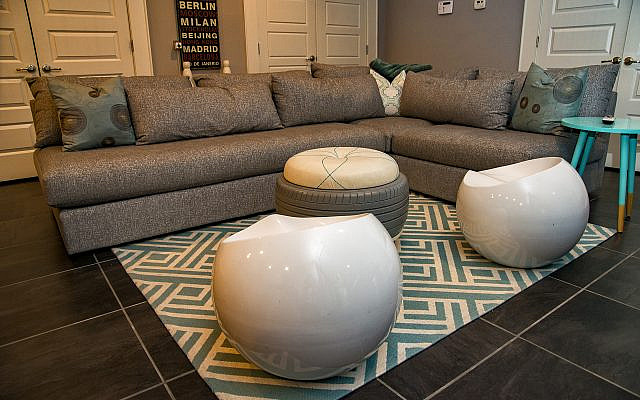 The lower level conversation pit features the white tires redesigned in South Africa to benefit women in need.