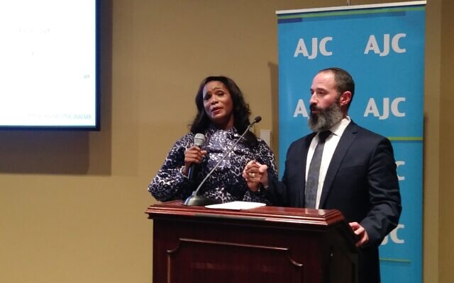Dr. Pauline Plummer and chazzan Daniel Gross of Detroit lead “We Shall Overcome.”