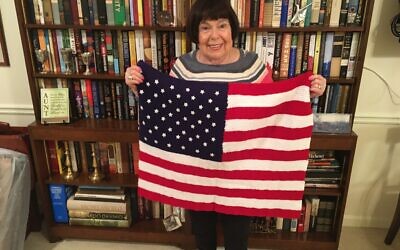 Olive Ellner holds one of the 24 blankets being donated this Veterans Day.