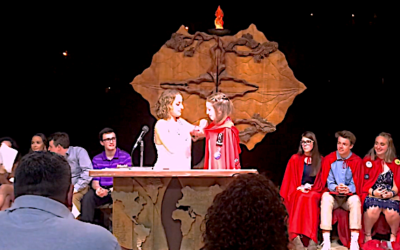 Sara Neuberger, on right, received a red cape when she was installed as president of the Southern Area Region of NFTY.