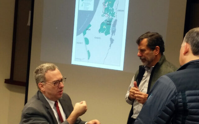 Horizontal: David Makovsky at a breakfast presentation at the ISMI Feb. 4. The map behind him overlays the 1949 Green Line, the separation barrier and areas of West Bank atop the two states envisioned by the Trump peace plan.