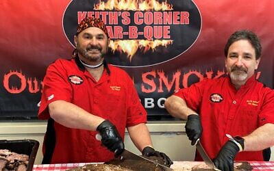 Keith Marks and David Schakett slicing briskets for delivery to those in need.