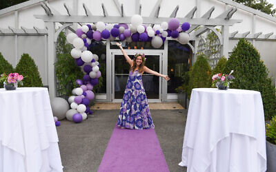 Photos by Jack Parada Photography//  Samatha welcomes guests under a purple cascade of balloons.