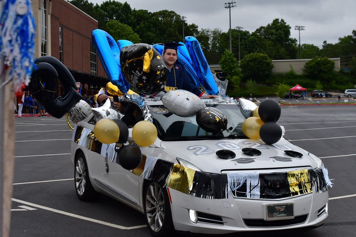 Photo by apPhotoMarietta LLC // Bradley Rudy is surrounded by balloons and other decorations at his non-traditional graduation from Walton High School.