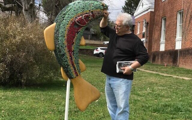Philip Karlick checks out the colorful trout sculpture.
