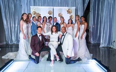 Shelly Danz, producer of the Bridal Extravaganza of Atlanta, poses with bride and groom models following a successful fashion show at the Southern Exchange Ballrooms in January.