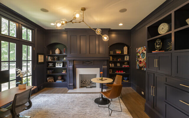 The study had a dramatic renovation with painted fireplace, tons of built-ins and cabinets painted a charcoal blue. Greenwald likes that her desk faces the street to watch the kids play. “Face” far right- Greenwald selected as fun pop art.
