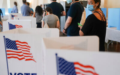 People waited in long lines on Tuesday to vote in Georgia’s primary. ELIJAH NOUVELAGE / GETTY IMAGES
