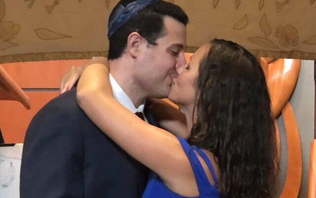 Stephanie Lievense and Andrew Cohn seal their union with a kiss.