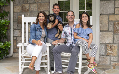 Photos by Duane Stork // The Levins enjoy the porch of their replica of an 18th century Pennsylvania stone farmhouse with Greek revival columns. Front and center is newly adopted mini Aussie Allie.
