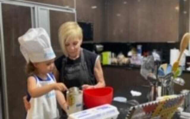 Marianne Garber with 3-year-old Zadie baking for the holidays.