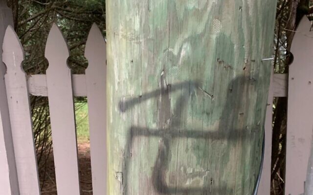Someone painted the swastikas and scrawled the word MAGA at least once on several fences on Holly Springs Road.