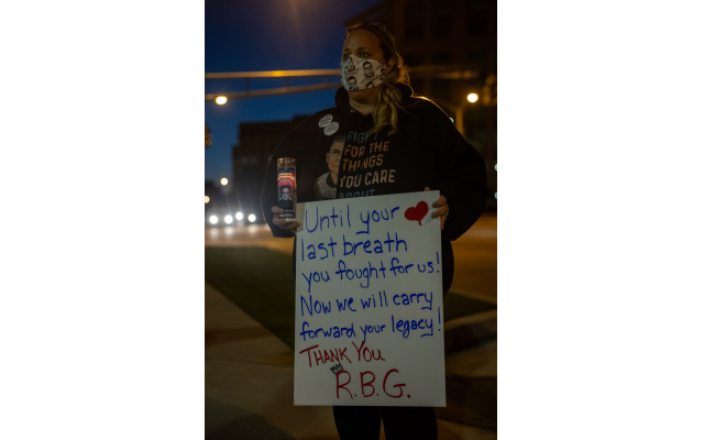 A woman holds a sign honoring the late Justice Ginsburg at a candlelight vigil outside the Georgia Supreme Court building in downtown Atlanta. // Nathan Posner for the AJT.