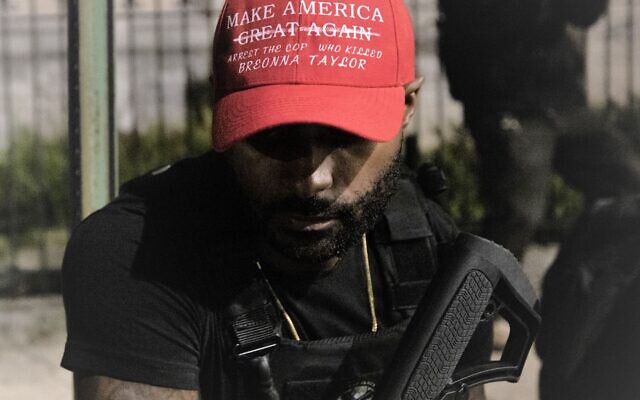 A member of the “Black Revolutionaries,” wears a hat mocking the Make America Great Again hats of the Trump campaign that reads “Make America Great Again Arrest The Cop Who Killed Breonna Taylor.”// Nathan Posner for the AJT.