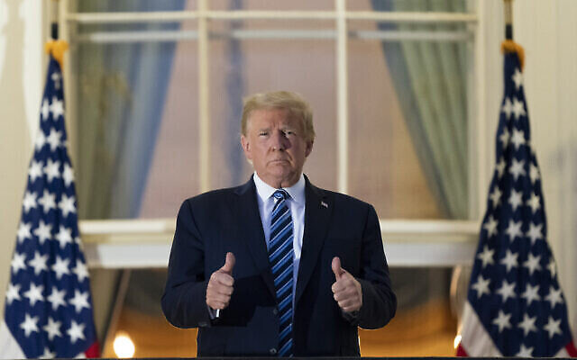 President Donald Trump gives thumbs up on the Blue Room Balcony upon returning to the White House Monday, Oct. 5, 2020, in Washington, after leaving Walter Reed National Military Medical Center, in Bethesda, Md. Trump announced he tested positive for COVID-19 on Oct. 2. (AP Photo/Alex Brandon)