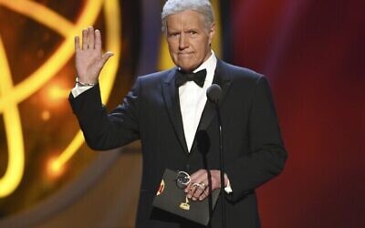 This May 5, 2019, file photo shows Alex Trebek gestures while presenting an award at the 46th annual Daytime Emmy Awards in Pasadena, Calif. Jeopardy!” host Alex Trebek died Sunday, Nov. 8, 2020, after battling pancreatic cancer for nearly two years. Trebek died at home with family and friends surrounding him, “Jeopardy!” studio Sony said in a statement. Trebek presided over the beloved quiz show for more than 30 years. (Photo by Chris Pizzello/Invision/AP, File)
