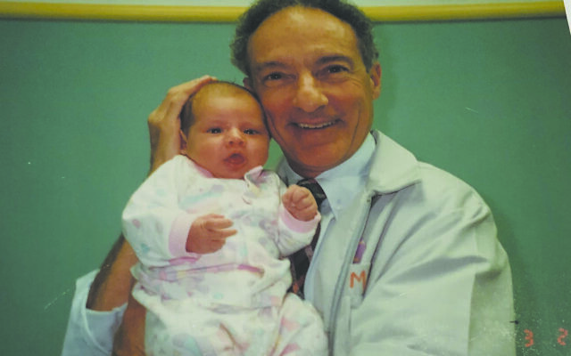 Pediatrician Dr. Mike Levine stands with one of his patients in 1994.