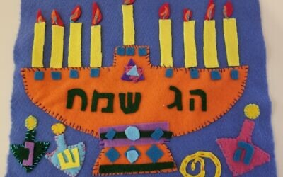 Felt cutouts with embroidery and blanket stitching becomes a small Chanukah wall hanging.