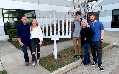 Adam Arno in front of the menorah with his family: Richard, Pearl, Adam, Sheryl and Eliot.