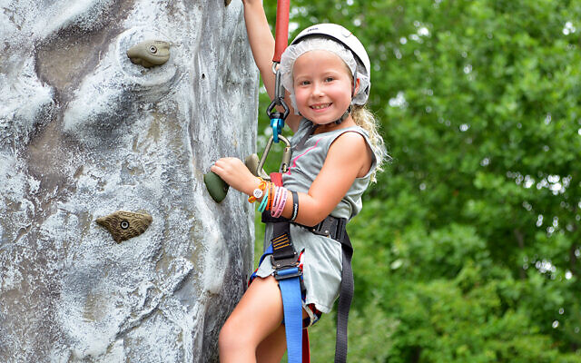A camper from MJCCA Day Camps rock climbing.