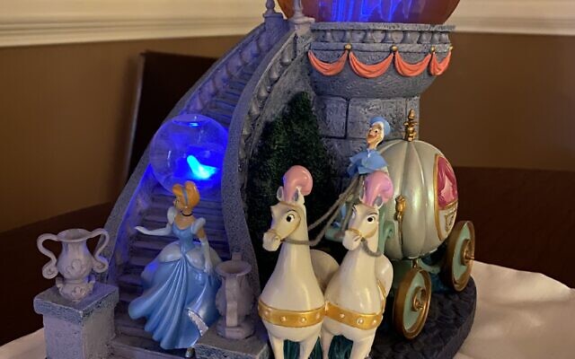 This large snow globe tells the entire Cinderella story. Note the blue slipper on the stairs.