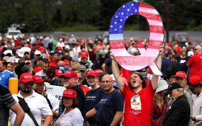 David Reinert holds up a large "Q" sign while waiting in line to see President Donald J. Trump at his rally on August 2, 2018 at the Mohegan Sun Arena at Casey Plaza in Wilkes Barre, Pennsylvania. Rick Loomis / Getty Images