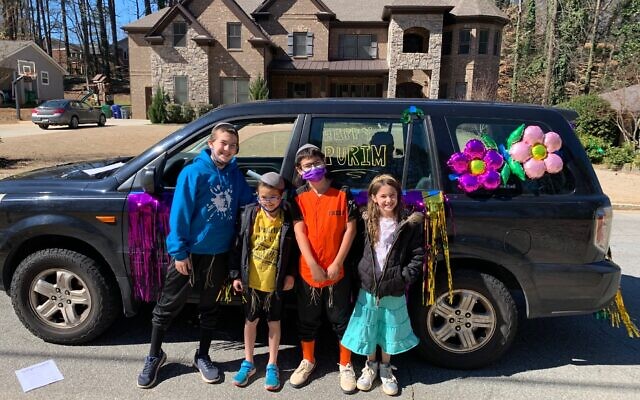 The Wasserman family steps out of their car to pose during the scavenger hunt.